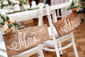 Hochzeitstisch des Brautpaares mit Mrs. und Mr. Beschriftungen auf Holztafeln