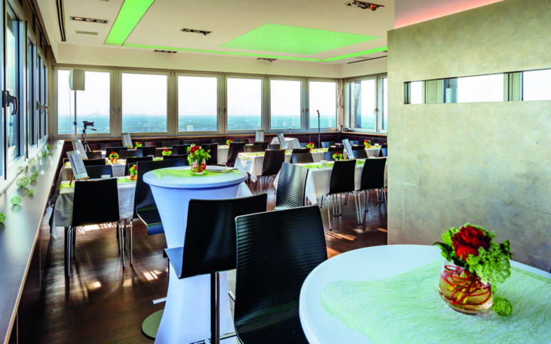 Bestuhlte Eventlocation in Restaurant mit bodentiefen Fenstern mit toller Aussicht