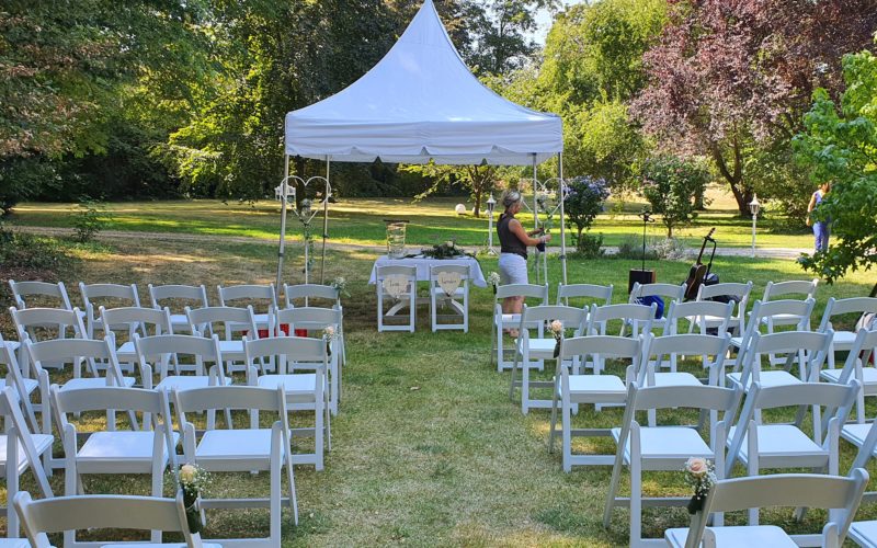 Hochzeitslocation in Grevenbroich - Kleiner weißer Pavillon im Freien mit Tisch und weißen Stühlen